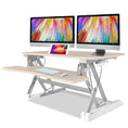 Load image into Gallery viewer, Fortia Desk Riser 90cm Wide Adjustable Sit to Stand for Dual Monitor, Keyboard, Laptop, Beech